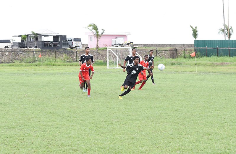 Christianburg Wismar tackling St Stanislaus in the ExxonMobil U-14 eliminator