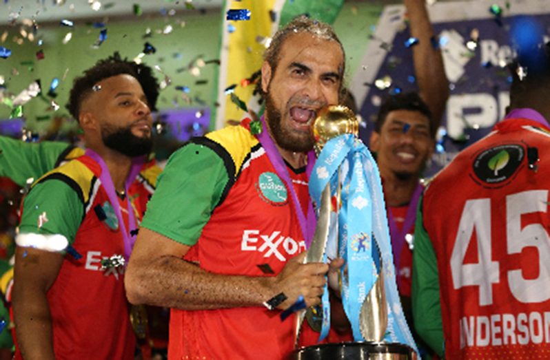 Guyana Amazon Warriors captain Imran Tahir celebrates with the Caribbean Premier League trophy on Sunday night. (Photo courtesy CPLT20/Getty Images)