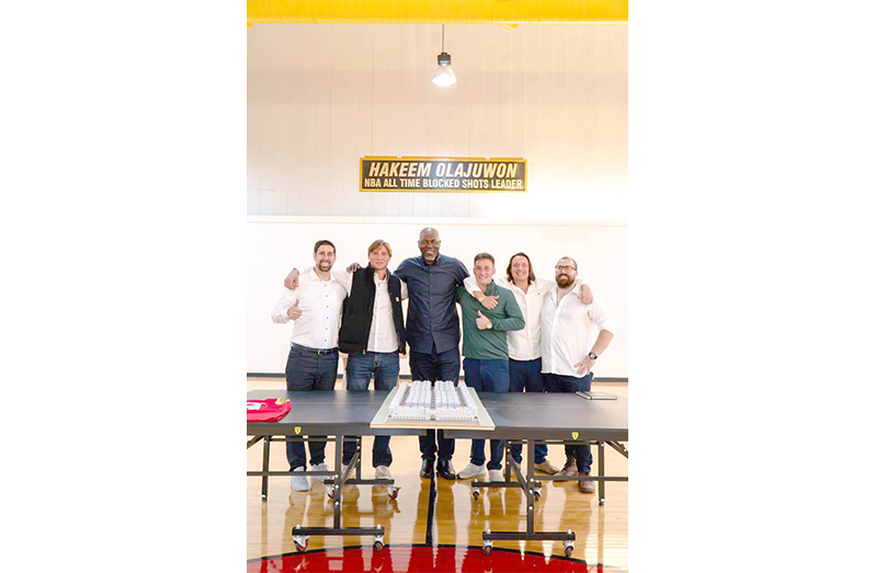 NBA legend Hakeem Olajuwon stands with members of the Coastal Rim Properties leadership team after confirming his investment and home purchase at the TAJ DIAMOND master-planned community in Guyana
