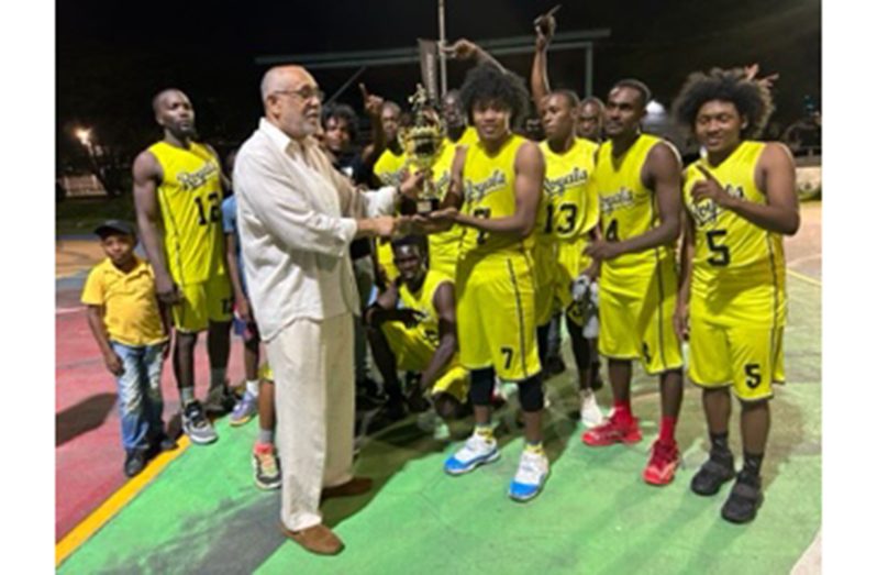 Roy Spooner at left hands over Championship Trophy to Royals' captain Yannick Tappin