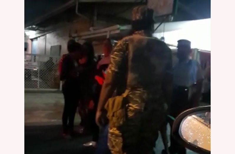 A snippet from a video of officers of the Guyana Police Force (GPF) and the Guyana Defence Force (GDF) arresting patrons who were found in a local bar, in breach of the COVID-19 guidelines