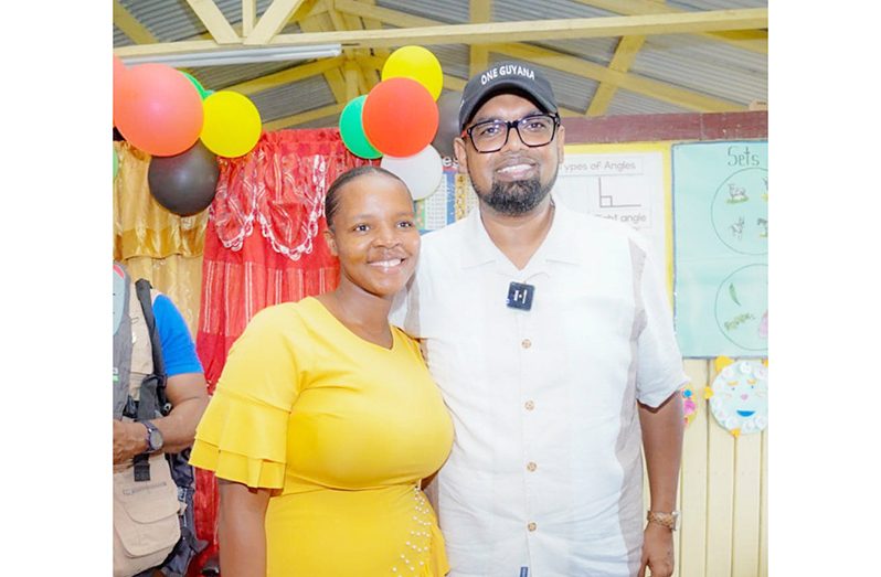 Teacher of Baracara Primary School, Ayecia Amsterdam, and President Dr Irfaan Ali during his visit to the Canje Creek community