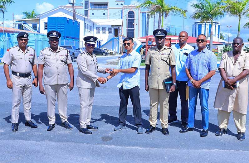 From left: Deputy Commissioner ‘Administration’ Mr. Ravindradat Budhram, Deputy Commissioner ‘Operations’ Mr. Errol Watts with Commissioner of Police Mr. Clifton Hicken who received the keys for the pickups from a representative of Queensway Security Services Inc. in the presence of other senior officers and CEO of Queensway Security Services Inc., Mr. Mohamed Qualander (second from right) who donated 21 Hilux pickups
