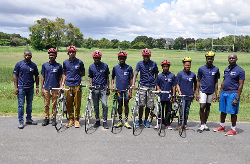 The Guyana team for the Junior Caribbean Cycling Championships posing with GCF President Horace Burrowes (left) and Assistant Racing Secretary, Joseph Britton( right) following the presentation of cycles and other equipment on Saturday last.