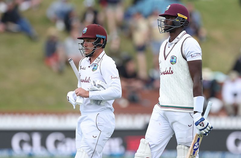 Joshua da Silva and Jason Holder leave the field. (Getty Images)