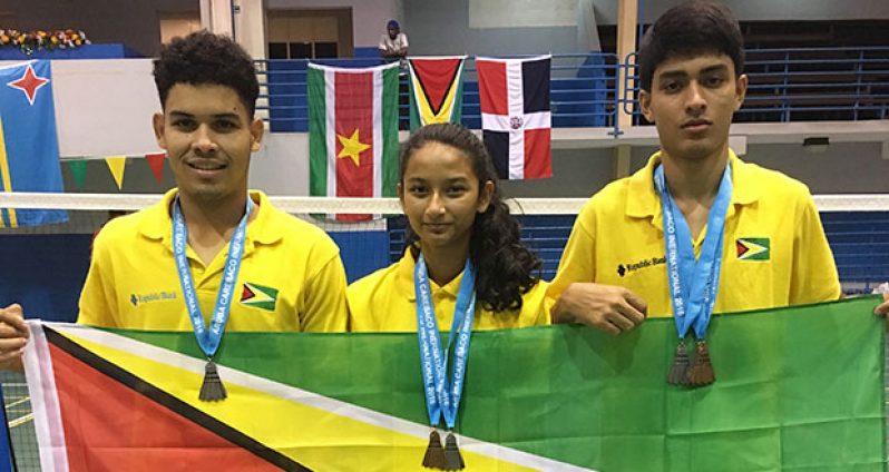 Guyana’s three-member team proudly display the Golden Arrowhead after they captured four silver and two bronze medals.