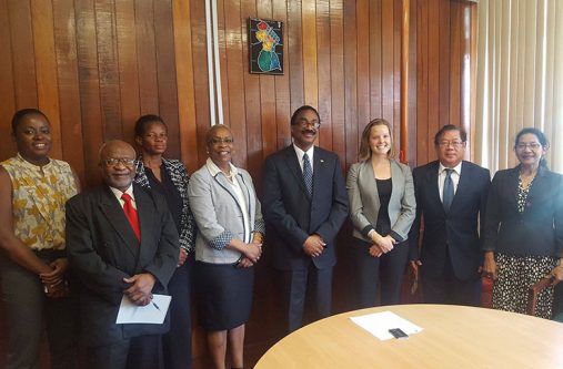 Attorney General Basil Williams and staff with members of the visiting Social Impact/USAID Monitoring and Evaluation Team