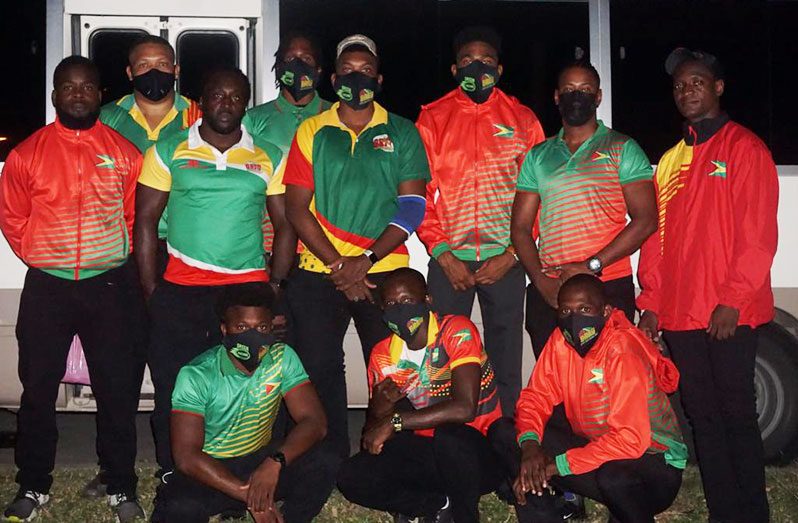 Coach Theodore Henry with some members of Guyana’s 7s rugby team – the Green Machine