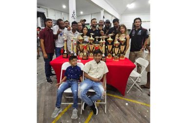 Shan Seejatan (Centre) with his team and trophies