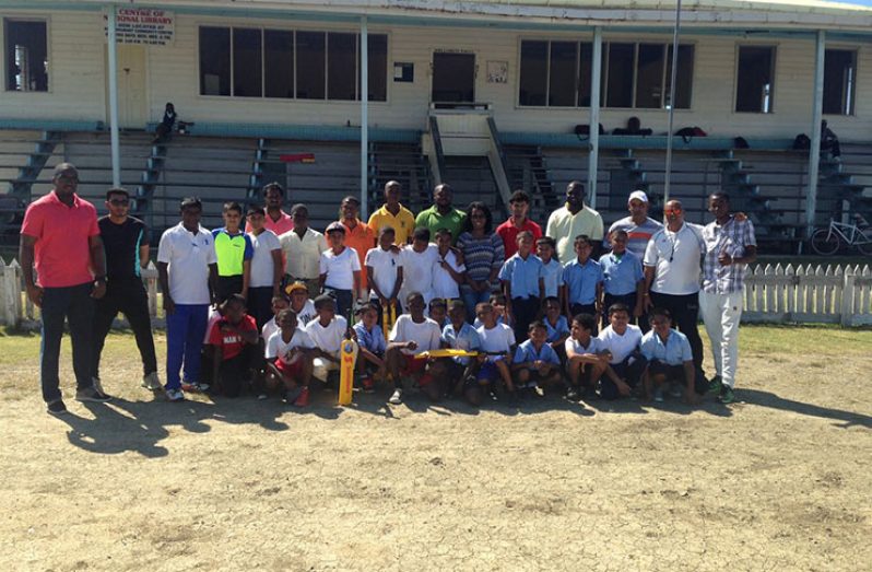 Rose Hall and Port Mourant Primary schools cricket teams strike a pose with their coaches and managers