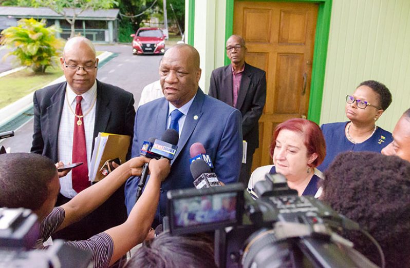 Director-General of the Ministry of the Presidency, Joseph Harmon, speaking with reporters at Castellani House. In the photo are representatives of the government and the opposition (Delano Williams photo)