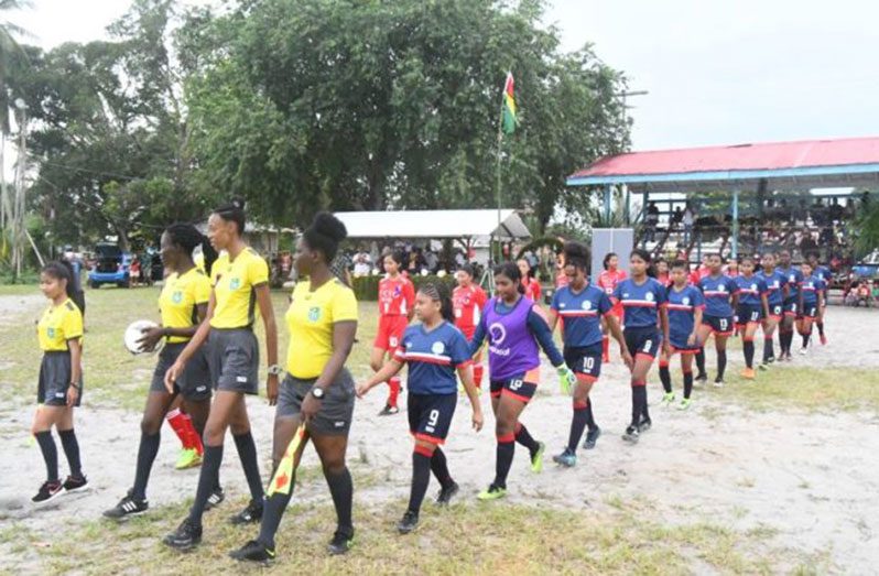 Moment in history cemented! Swan and St. Cuthbert’s Mission Female Football Teams along with match officials enter the field to commence battle in the opening match