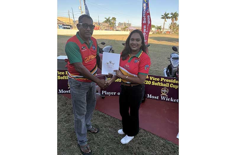 Telesha Ousman of Regal Stationery & Computer Centre hands over the sponsorship cheque.to manager Raymond Reeece