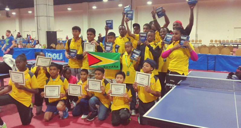 Team Guyana with the participation documents and medals