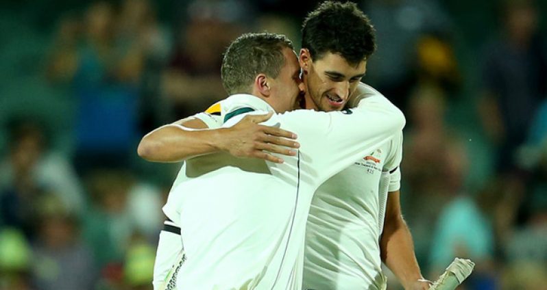 Peter Siddle and Mitchell Starc embrace after a tense finish in Adelaide.