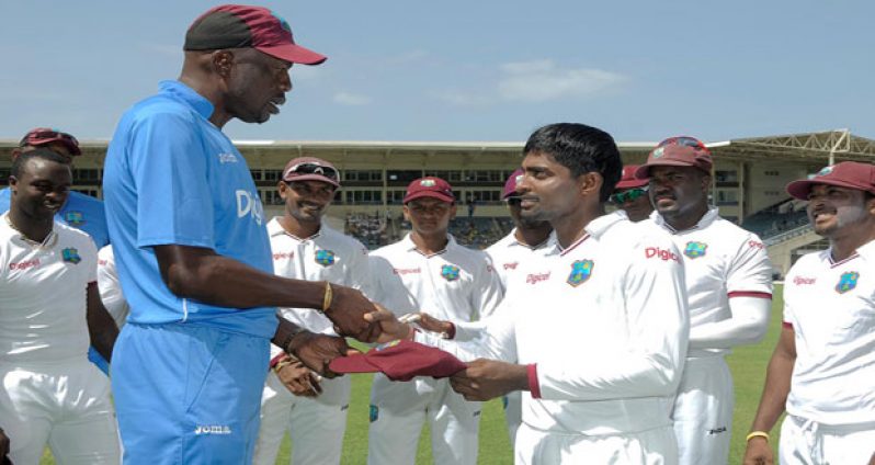 Rajendra Chandrika is handed his Test debut cap by West Indies legend Curtly Ambrose.