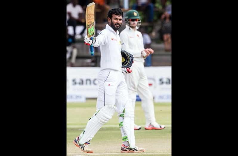 Upul Tharanga celebrates getting to a century on the second day in Harare.