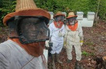 Aubrey Roberts, along with his two sons, at their Long Creek Apiary