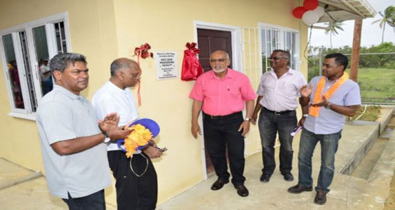 President Donald Ramotar and Agriculture Minister, Dr. Leslie Ramsammy unveil the plaque to the Number 56 Village rice seed facility. Also in photo are Head, Guyana Rice Development Board, Jagnarine Singh and Head of the Guyana Rice Producers Association, Dharamkumar Seeraj