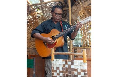 Eon John, also known as ‘The Singing Chef,’ with his guitar (Japheth Savory Photo)