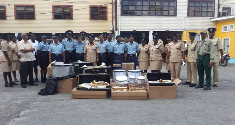 Junior and senior ranks pose with the instruments before they were handed over on Monday at Brickdam Police Station