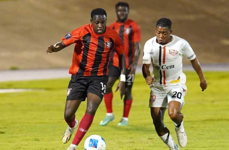 Jaheim Thomas of Arnett Gardens drives the ball against Rapha Intervil of Real Hope during the Group A match in the Concacaf Caribbean Cup, held at the National Stadium, in Kingston,