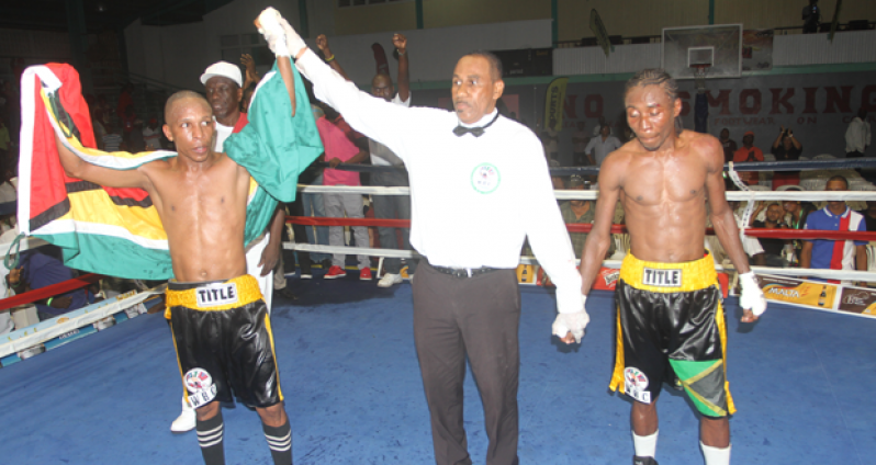 And the winner is! In this Sonell Nelson photograph, referee Andrew Thorne raises the hands of the victorious Dexter ‘The Kid’ Marques, following his unanimous points decision win over Jamaica’s Rudolph Hedge, which allowed Marques to retain his WBC/CABOFE flyweight title last Saturday night.
