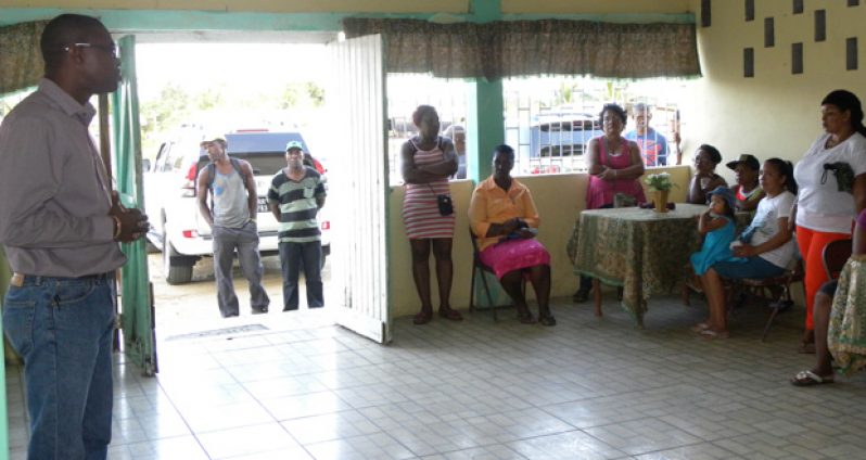 Minister of Public Infrastructure David Patterson, in discussion with some of the affected residents of Timehri North