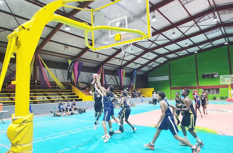 Caption 2. Queen’s College Jared Boucher going for a lay-up against Marian academy