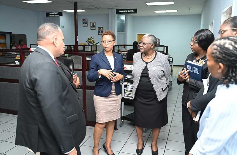 Housing Minister Collin Croal and Minister within the Ministry Vanessa Benn in discussion with Land Registry staff to find solutions to the growing backlogs linked to the rapid expansion of state housing schemes