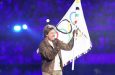 Actor Tom Cruise with the Olympic flag at the closing ceremony