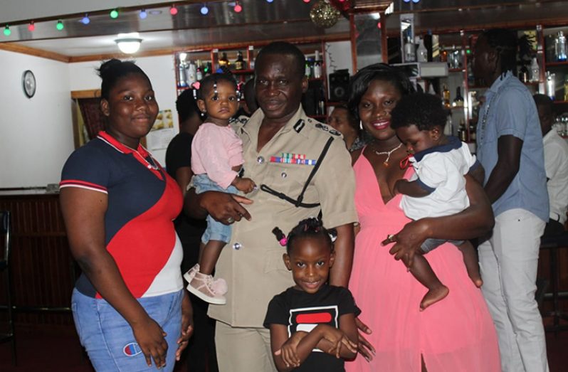 Commissioner of Police Leslie James interacts with one of the many families that attend the Children’s Christmas party.