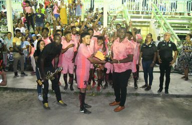 Regional Chairman Kenneth Williams hands over the top prize and trophy to the Rivers View captain in the presence of team-mates, BFA president Alden Marslow (right), and other executive members.