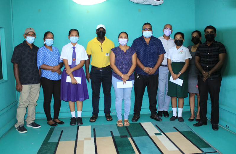 Top students, parents and teachers after receiving the awards