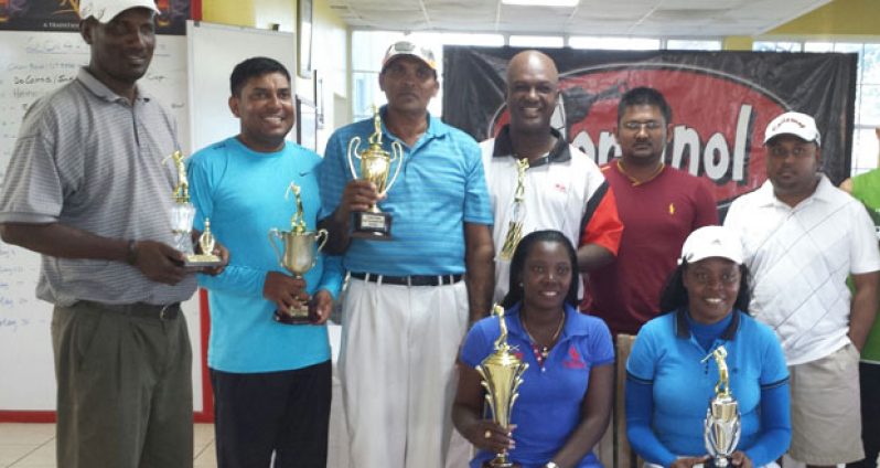 The respective prize winners pose with their trophies at the completion of the tournament. Sitting at left is overall winner Shanella Webster while vice-president of the Lusignan Golf Club David Mohamad is standing at right.