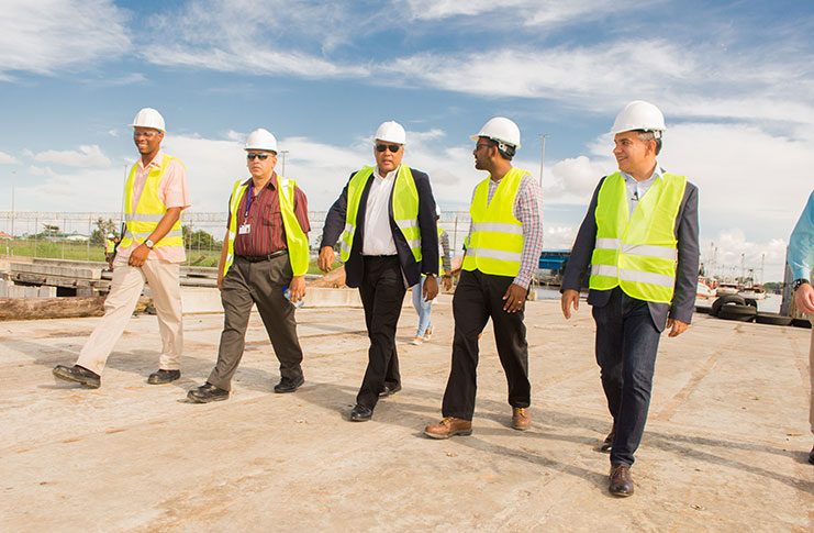Minister of Natural Resources, Raphael Trotman, tours the facility with officials of the Guyana Shore Base Inc.