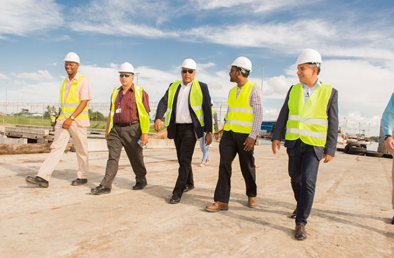 Minister of Natural Resources, Raphael Trotman, tours the facility with officials of the Guyana Shore Base Inc.