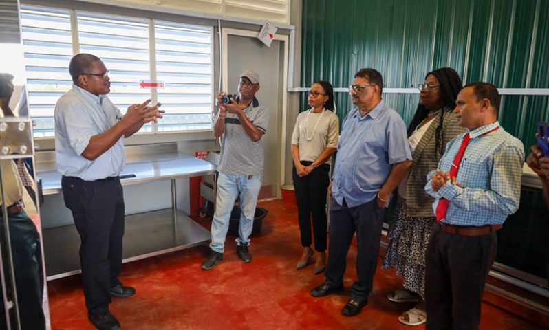 Minister Walrond receives a tour of the new facility (Department of Public Information photo)