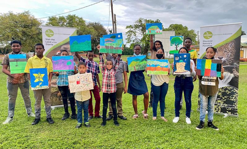 Children who participated in Sunday’s GTA event display their artwork (Guyana Tourism Authority photo)