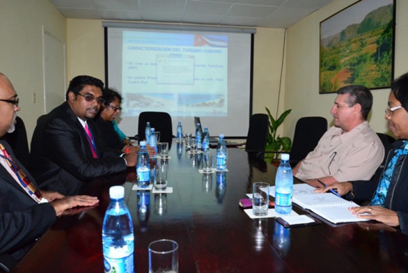 TOURISM TALKS: Minister of Tourism (ag), Mr Irfaan Ali (second left), and Guyana’s Ambassador to Cuba, Ms Mitra Devi Ally (third left) during their meet with Cuba’s Director of International Relations, Mr. Rosa Adela Mejias Jimenez (second left) in Havana. With him also is Head of the Government Information Agency (GINA), Mr Neaz Subhan (extreme left)