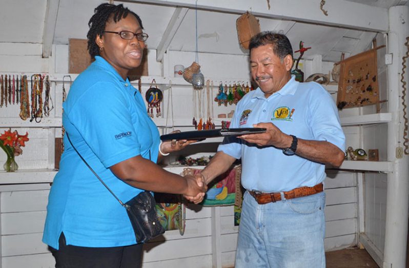 A member of the Barbados team presents a small token to Minister of Indigenous Peoples’ Affairs, Sydney Allicock