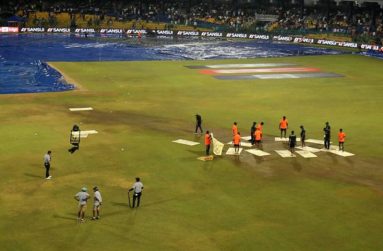 Members of the groundstaff attempted to dry the outfield with towels.