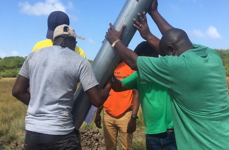 Technicians installing the wind station (Photo Credit : Ministry of Public Infrastructure )