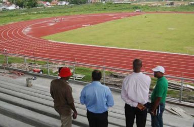 Minister of Sport Dr Frank Anthony, second left, and other Ministry staff take an aerial view of Guyana’s first synthetic track and its markings. (Cullen Bess-Nelson photo)