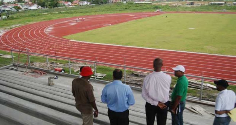 Minister of Sport Dr Frank Anthony, second left, and other Ministry staff take an aerial view of Guyana’s first synthetic track and its markings. (Cullen Bess-Nelson photo)