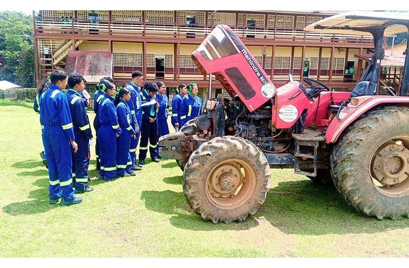 Students of Port Kaituma Secondary School gaining valuable hands-on experience in a  practical session focused on agricultural machinery and equipment