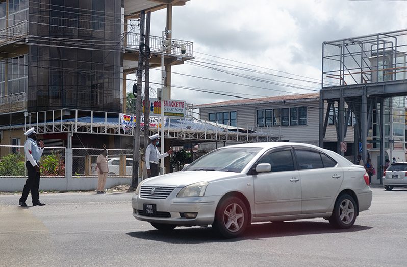Traffic ranks performing duties at the Demerara Harbour Bridge on Saturday (Delano Williams photo)