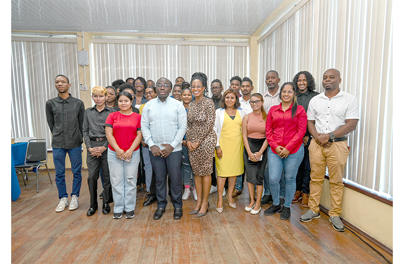 Minister in the Office of the Prime Minister, Kwame McCoy, joins participants of the Guyana Media and Communication Academy’s nine-week digital media training programme during a visit to the Racquet Centre on Friday