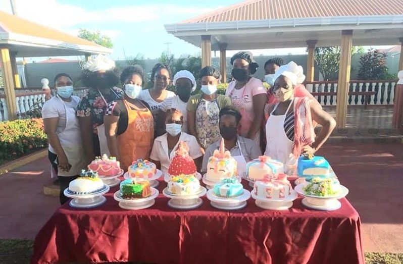 Participants of a baking (cake decorating) class showcasing what they had learnt
