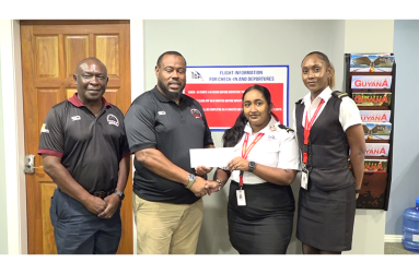 Petra Director Troy Mendonca collects the sponsorship cheque from Trans Guyana Airways Commercial Operations Officer Pooja Jagroo. They are flanked by Petra Rep Troy Peters and Trans Guyana Airways Senior officials